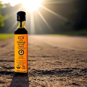 Bottle of Mahua Nectar Gold – Premium Mahua Elixir (350ml) placed outdoors with sunlight in the background, showcasing natural forest heritage and tribal-crafted wellness.