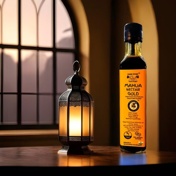 Bottle of Mahua Nectar Gold – Premium Mahua Elixir (350ml) placed beside a glowing lamp indoors, symbolizing purity, warmth, and luxury in tribal-crafted wellness.