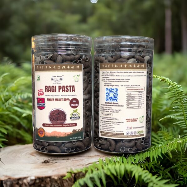 Clear PET jars of Ragi Pasta Premium (50% Finger Millet, No Maida), crafted by tribal women of Jashpur, displayed on a wooden surface with green ferns in the background.