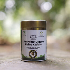 Buckwheat Jaggery Mahua Cookies in tin container with cookies served on wooden tray.