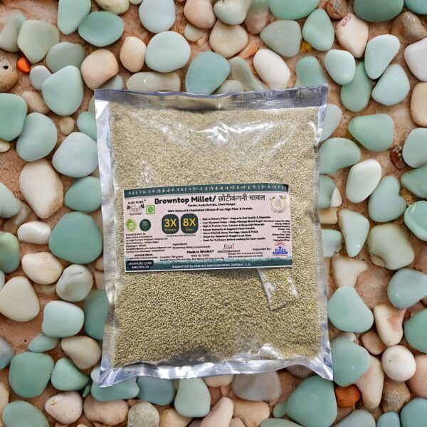 Sealed pack of Browntop Millet (Korale, Andakorra) from Jai Jungle on smooth pebbled surface