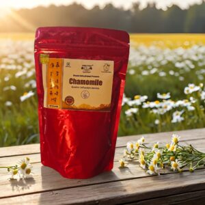 Front packaging of Jai Jungle Chamomile Loose Tea 50g placed on wooden table with chamomile flowers in background.